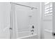 Bright bathroom features a clean, white tile shower with a shower curtain at 3010 E Fruitvale Ave, Gilbert, AZ 85297