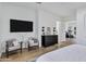 Bright bedroom with seating area, dresser, and views into home gym at 3010 E Fruitvale Ave, Gilbert, AZ 85297