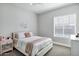 Cozy bedroom featuring plush bedding, neutral walls, and natural lighting from window at 3010 E Fruitvale Ave, Gilbert, AZ 85297