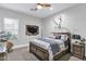 Bedroom featuring stylish decor, ceiling fan, and wooden accents for a modern, comfortable space at 3010 E Fruitvale Ave, Gilbert, AZ 85297