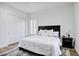 Bright bedroom features a large bed with crisp white linens and wood floors at 3010 E Fruitvale Ave, Gilbert, AZ 85297