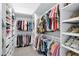 Walk-in closet with custom shelving and ample storage space for clothes at 3010 E Fruitvale Ave, Gilbert, AZ 85297