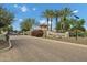 Stone entrance to Weston Ranch neighborhood with palm trees and manicured landscaping on a sunny day at 3010 E Fruitvale Ave, Gilbert, AZ 85297
