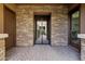 A serene brick courtyard entrance with a secure iron gate and exterior brick walls at 3010 E Fruitvale Ave, Gilbert, AZ 85297