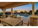 Outdoor dining area with a view of the stunning pool and landscaped backyard at 3010 E Fruitvale Ave, Gilbert, AZ 85297