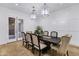 Dining room features a dark wood dining table, seating for eight, and decorative pendant lighting at 3010 E Fruitvale Ave, Gilbert, AZ 85297