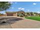 Lovely home with a three car garage, brick driveway, manicured landscaping and green lawn at 3010 E Fruitvale Ave, Gilbert, AZ 85297