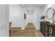 Bright hallway featuring hardwood floors, white walls, and decorative accents, creating a clean and inviting entryway at 3010 E Fruitvale Ave, Gilbert, AZ 85297