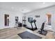 Bright home gym with wood floors, treadmill, and various exercise equipment at 3010 E Fruitvale Ave, Gilbert, AZ 85297