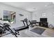 Home gym with treadmill, free weights and various exercise equipment and television at 3010 E Fruitvale Ave, Gilbert, AZ 85297