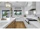 Bright kitchen featuring stainless steel appliances, white cabinetry, and a view of the backyard pool at 3010 E Fruitvale Ave, Gilbert, AZ 85297