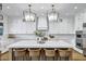 Spacious kitchen featuring a large island, white cabinets, modern appliances, and stylish pendant lighting at 3010 E Fruitvale Ave, Gilbert, AZ 85297