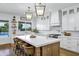 Bright kitchen with a large island, white cabinetry, stainless steel appliances, and views to the backyard pool at 3010 E Fruitvale Ave, Gilbert, AZ 85297