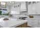 Bright kitchen featuring a large island with seating, modern appliances, and a stylish range hood at 3010 E Fruitvale Ave, Gilbert, AZ 85297
