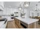 Open kitchen with large island, stainless appliances, and pendant lighting next to a dining area at 3010 E Fruitvale Ave, Gilbert, AZ 85297