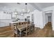 Open layout with an expansive kitchen island, dining table, and modern lighting at 3010 E Fruitvale Ave, Gilbert, AZ 85297