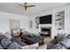 Comfortable living area with a fireplace, built-in shelving, cozy seating, and a ceiling fan at 3010 E Fruitvale Ave, Gilbert, AZ 85297
