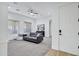 Spacious living room with a ceiling fan, carpeted floor, and a comfortable sofa at 3010 E Fruitvale Ave, Gilbert, AZ 85297