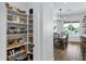 Organized pantry with shelves filled with storage containers and baskets next to the dining and pool view at 3010 E Fruitvale Ave, Gilbert, AZ 85297