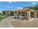 Neighborhood park pavilion with picnic tables, bike rack, and playground with blue skies in background at 3010 E Fruitvale Ave, Gilbert, AZ 85297