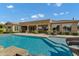 Backyard featuring an in-ground pool and slide adjacent to the covered patio at 3010 E Fruitvale Ave, Gilbert, AZ 85297