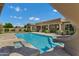 Sparkling pool and slide set against a backdrop of the home's covered patio at 3010 E Fruitvale Ave, Gilbert, AZ 85297