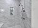 Luxurious shower with marble tile, built-in shelves, and sleek fixtures at 3010 E Fruitvale Ave, Gilbert, AZ 85297
