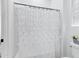 Close up of the bathroom showing a decorative shower curtain and tiled floors at 3010 E Fruitvale Ave, Gilbert, AZ 85297