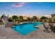 Stunning pool area with slide, water features, lounge chairs, and lush landscaping, perfect for relaxation at 3010 E Fruitvale Ave, Gilbert, AZ 85297