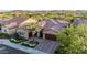 Expansive aerial view of a well-manicured home showcasing landscaping, tile roof, and desert surroundings at 30404 N 131St Dr, Peoria, AZ 85383