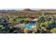 Stunning aerial view of a resort-style pool area, clubhouse, and surrounding desert landscape at 30404 N 131St Dr, Peoria, AZ 85383