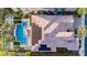 Aerial view of a backyard featuring a geometric pool, lounge chairs and solar panels on roof at 30404 N 131St Dr, Peoria, AZ 85383