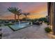 Beautiful backyard featuring a modern pool, mature palm trees, and an inviting outdoor seating area, perfect for entertaining at 30404 N 131St Dr, Peoria, AZ 85383