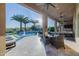 Luxurious outdoor area with a sparkling pool, covered patio, and beautifully landscaped surroundings at 30404 N 131St Dr, Peoria, AZ 85383