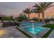 Backyard pool with fountains, palm trees, and a cozy seating area, offering a serene outdoor retreat at 30404 N 131St Dr, Peoria, AZ 85383