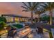Spacious backyard with a fire pit, pool, palm trees, and outdoor seating, perfect for entertaining at 30404 N 131St Dr, Peoria, AZ 85383