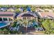 Backyard of a house with a sparkling pool, palm trees, and solar panels on the roof at 30404 N 131St Dr, Peoria, AZ 85383