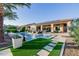 Stunning backyard with a pool, fire pit, manicured lawn, and a spacious covered patio at 30404 N 131St Dr, Peoria, AZ 85383