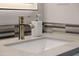 Bathroom close-up showcasing stylish faucet, quartz countertop, and modern decor at 30404 N 131St Dr, Peoria, AZ 85383