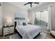 Serene bedroom featuring a ceiling fan, stylish white nightstands, and natural light streaming through the blinds at 30404 N 131St Dr, Peoria, AZ 85383