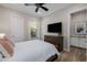 Comfortable bedroom with light walls, a modern dresser, and a door leading to the outside at 30404 N 131St Dr, Peoria, AZ 85383