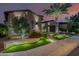 Twilight shot of an estate featuring desert landscaping with ambient lighting and a palm tree at 30404 N 131St Dr, Peoria, AZ 85383