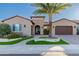 Beautiful single Gathering home with desert landscaping, a brick walkway and mature palm tree at 30404 N 131St Dr, Peoria, AZ 85383