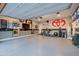 Finished garage featuring a Toyota logo, gym equipment, and a flat screen, creating a multipurpose fitness and entertainment area at 30404 N 131St Dr, Peoria, AZ 85383