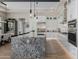 Modern kitchen with granite island, stainless steel appliances, and ample white cabinetry at 30404 N 131St Dr, Peoria, AZ 85383