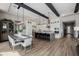 Spacious kitchen and dining area with white cabinets, a large island, and stylish seating and lighting at 30404 N 131St Dr, Peoria, AZ 85383
