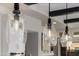 Pendant lights illuminate the kitchen island, highlighting its design and functionality at 30404 N 131St Dr, Peoria, AZ 85383