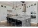 Well-lit kitchen featuring a large island, stainless steel appliances, and white cabinets at 30404 N 131St Dr, Peoria, AZ 85383