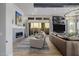 Cozy living room with a modern fireplace, neutral décor, and sliding glass doors to outdoor space at 30404 N 131St Dr, Peoria, AZ 85383