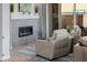 Bright living room with stone fireplace, modern furniture, and sliding glass doors to a private patio at 30404 N 131St Dr, Peoria, AZ 85383